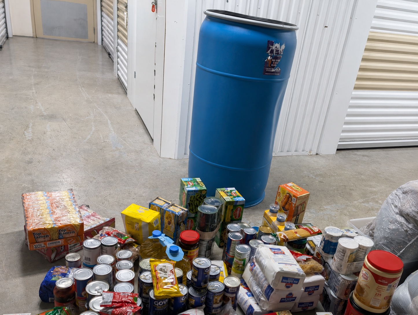 A blue shipping barrel with the food that Light On The Road is preparing to pack for Honduras