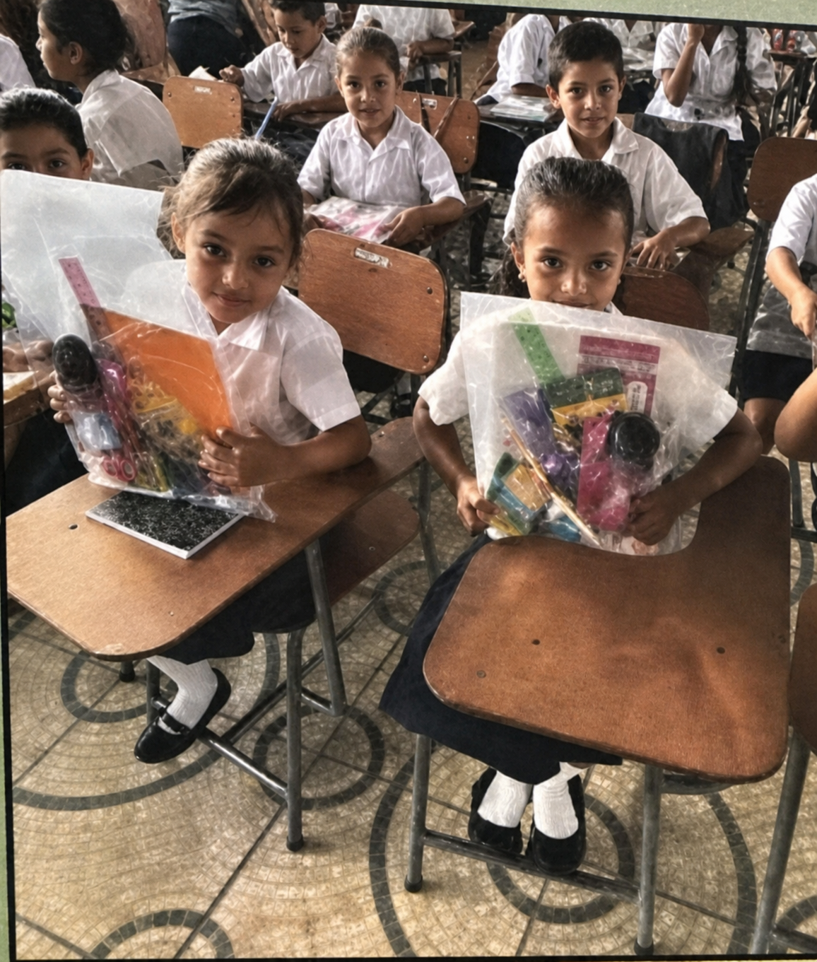 Students in Honduras holding school-supply care packages