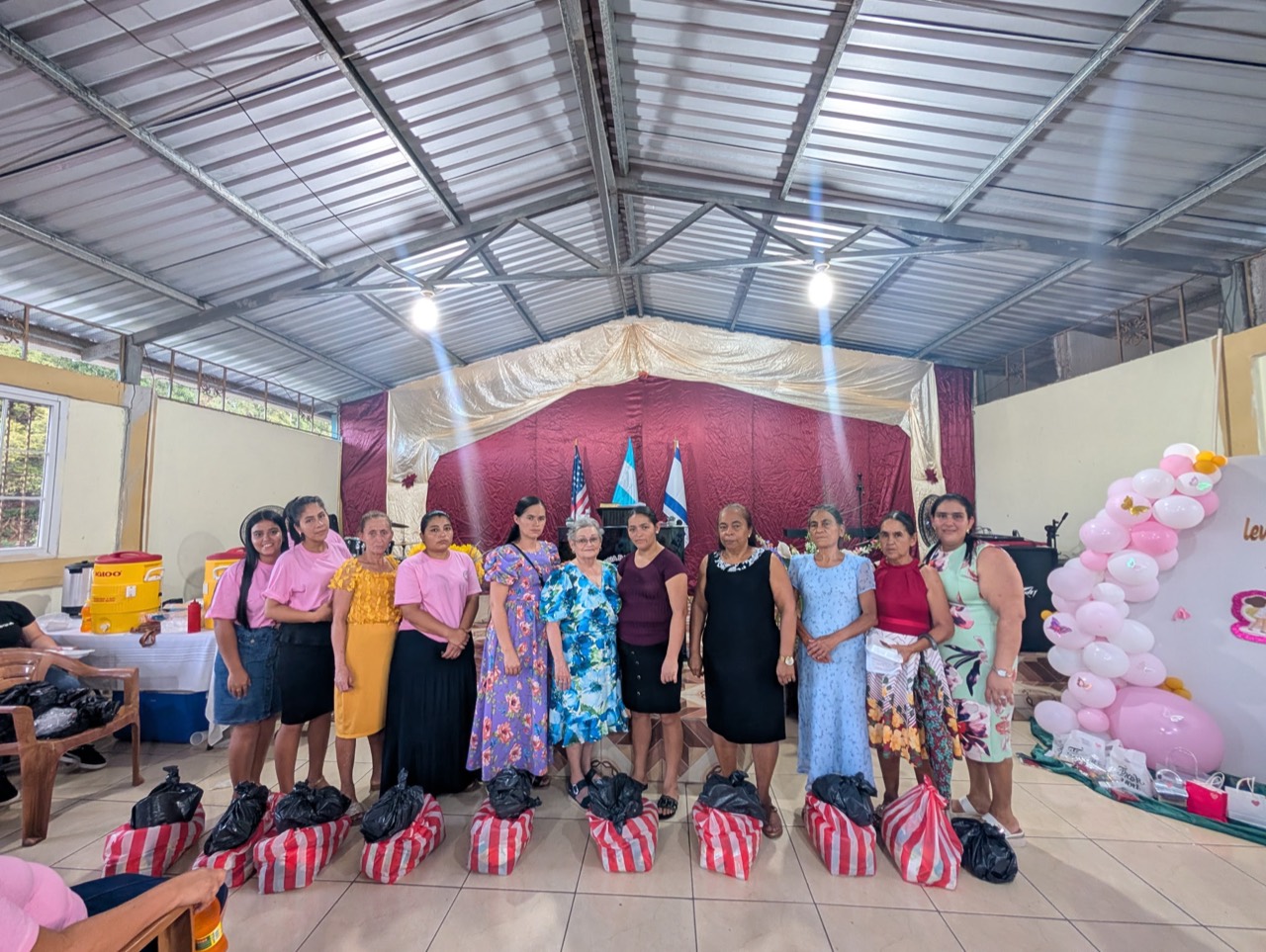 Women gathered at church with aid packages