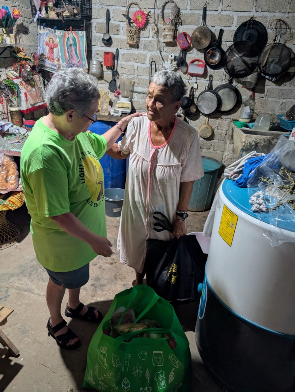 Rosa offering comfort and practical help to an elderly woman