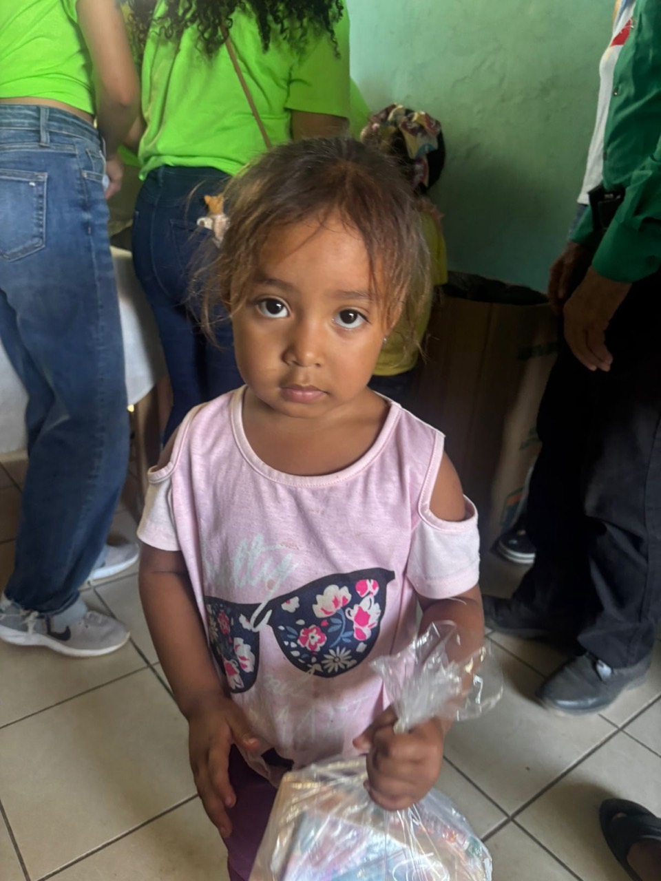 A young child holding a care package