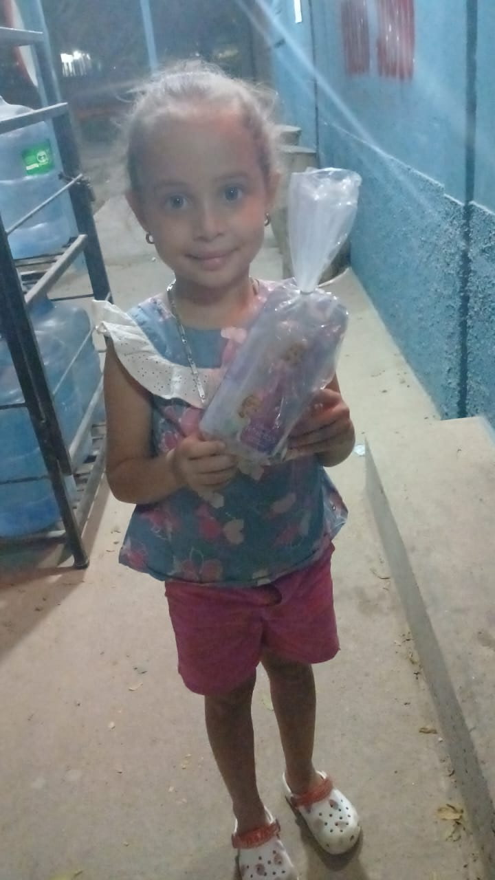 A young girl holding a small gift